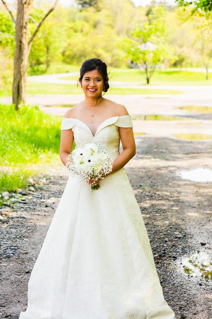 Bride in ivory gown that is off the shoulder