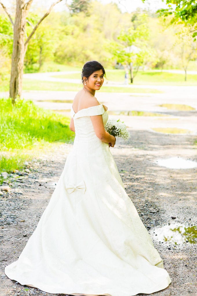 Bride in ivory gown looking over her shoulder