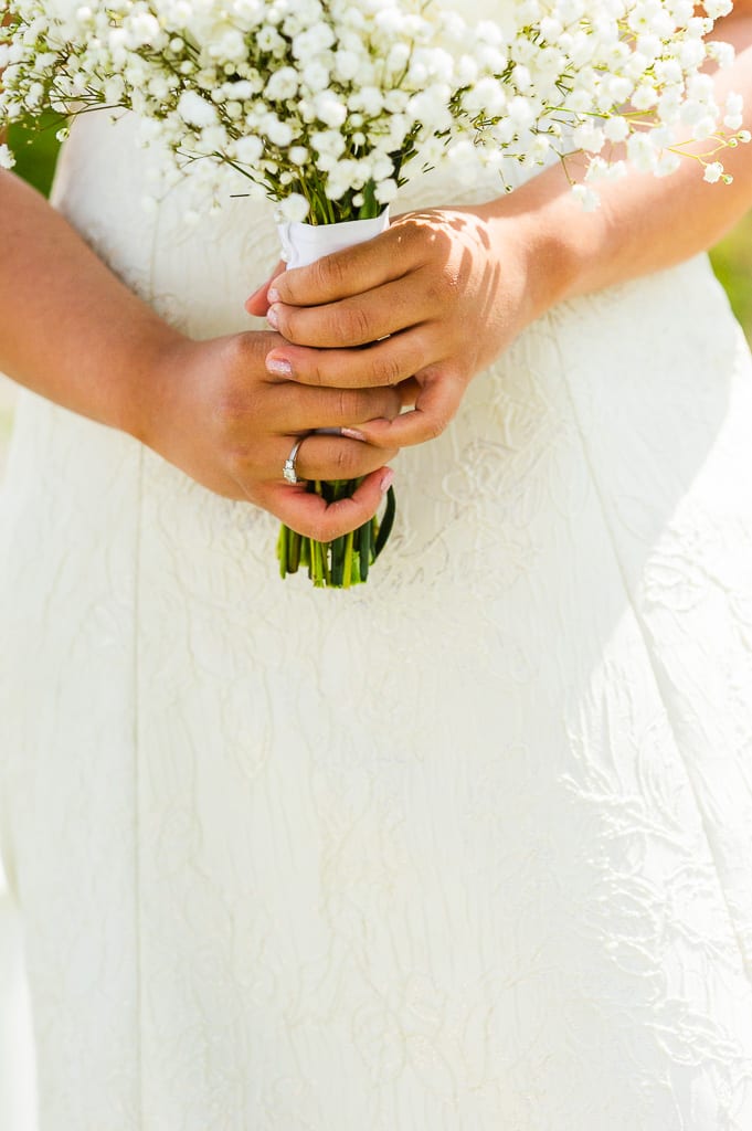 Bride with baby breath bouquet in an off white dress