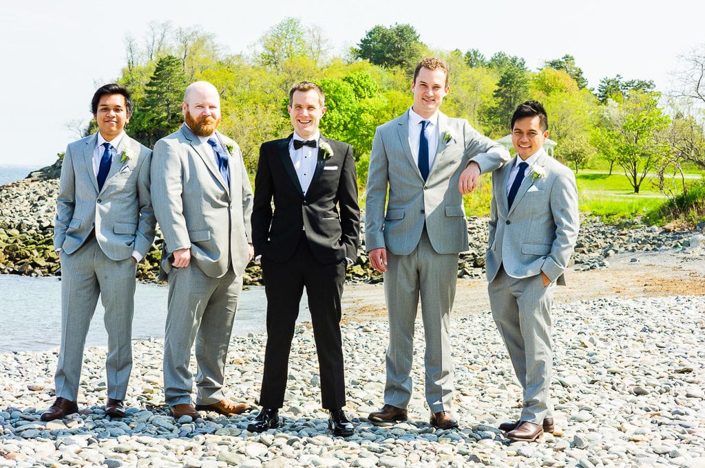 Groomsmen on the beach in gray suits at the oceanview in Nahant