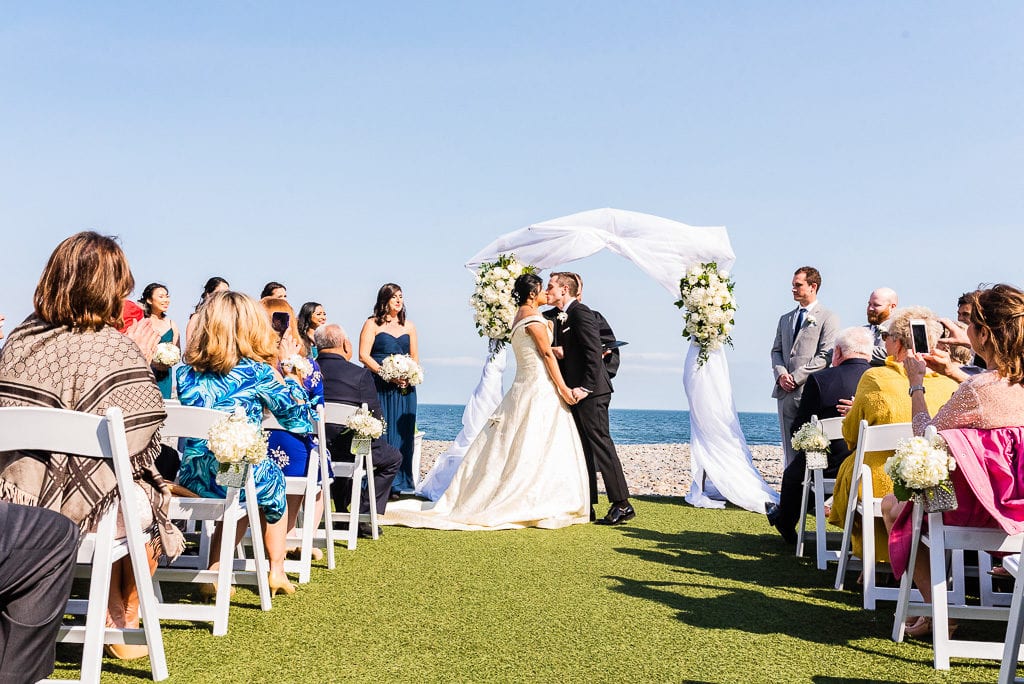 Bride and Groom kissing at ceremony Oceanview of Nahant