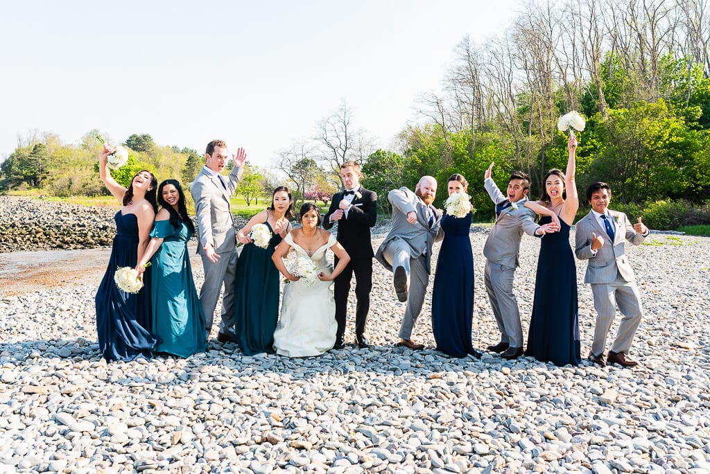Wedding party on the beach in a fun pose