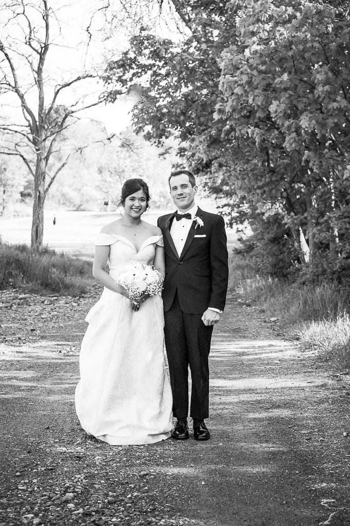 Bride and groom in black and white looking at the camera in a classic pose
