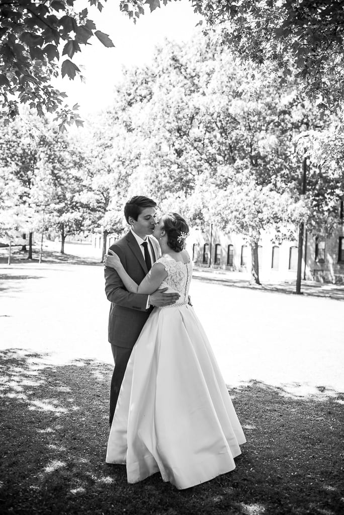 Bride and groom kissing in park. Black and white
