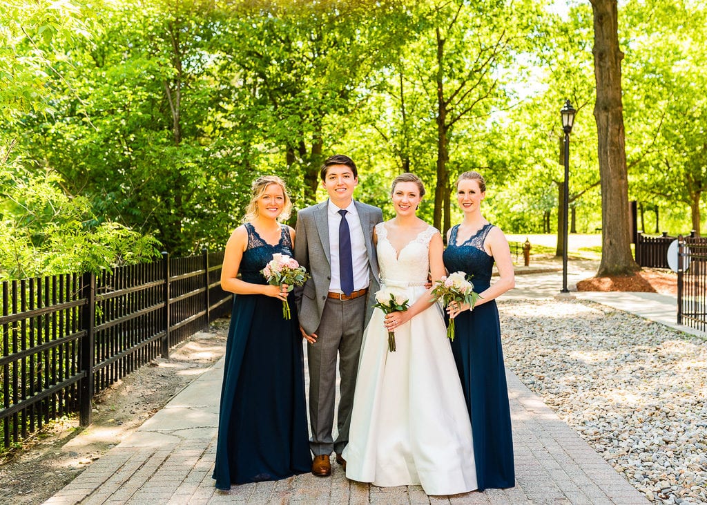 Bride and groom with bridesmaids in a park