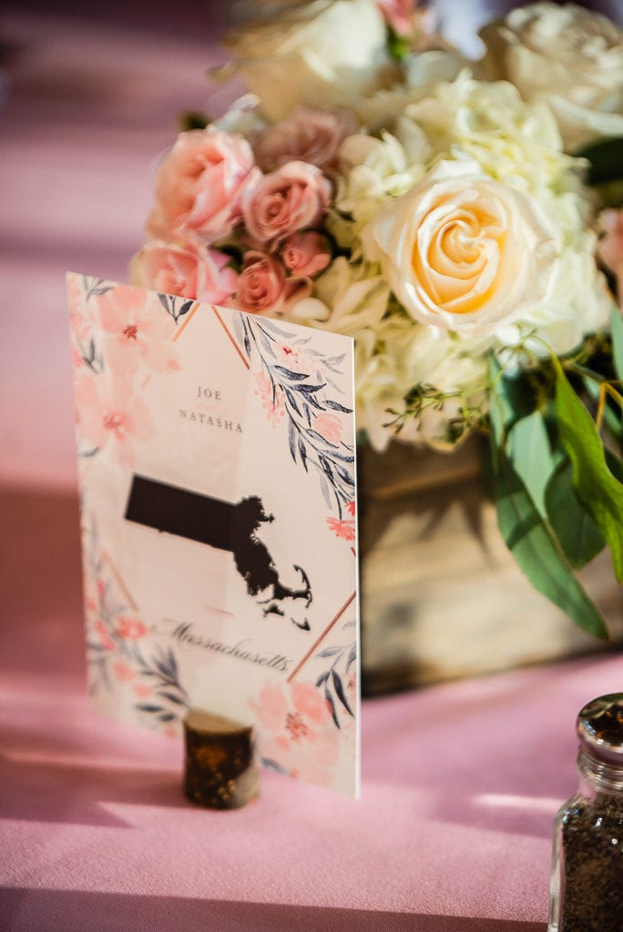 table numbers for wedding states instead of numbers pink tablecloth and soft romantic flowers