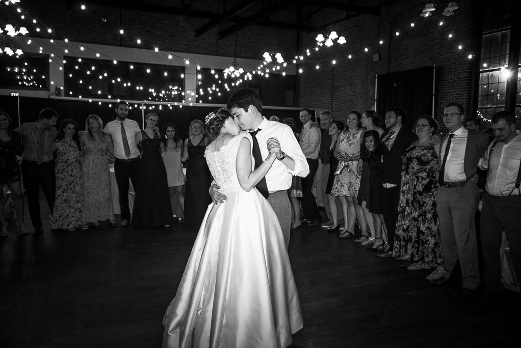 Bride and groom embrace during first dance