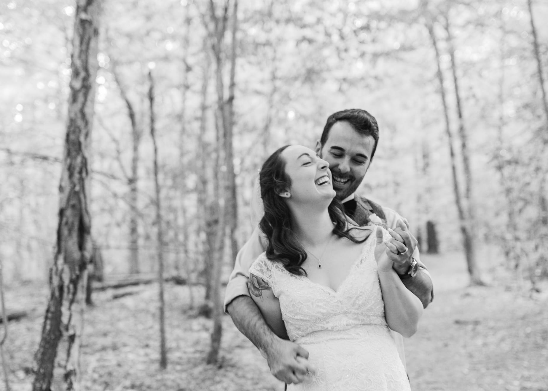 Black and white bride and groom laughing